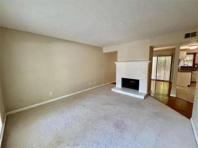 a view of empty room with a fireplace