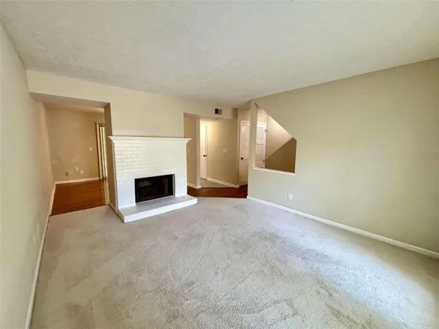 a view of an empty room with a fireplace