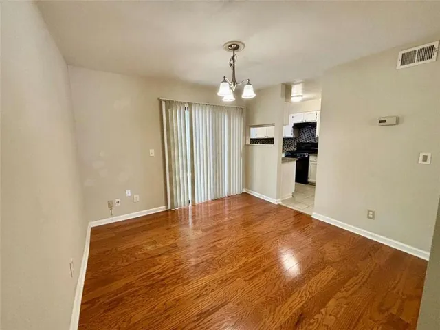 a view of a kitchen with a sink and a refrigerator