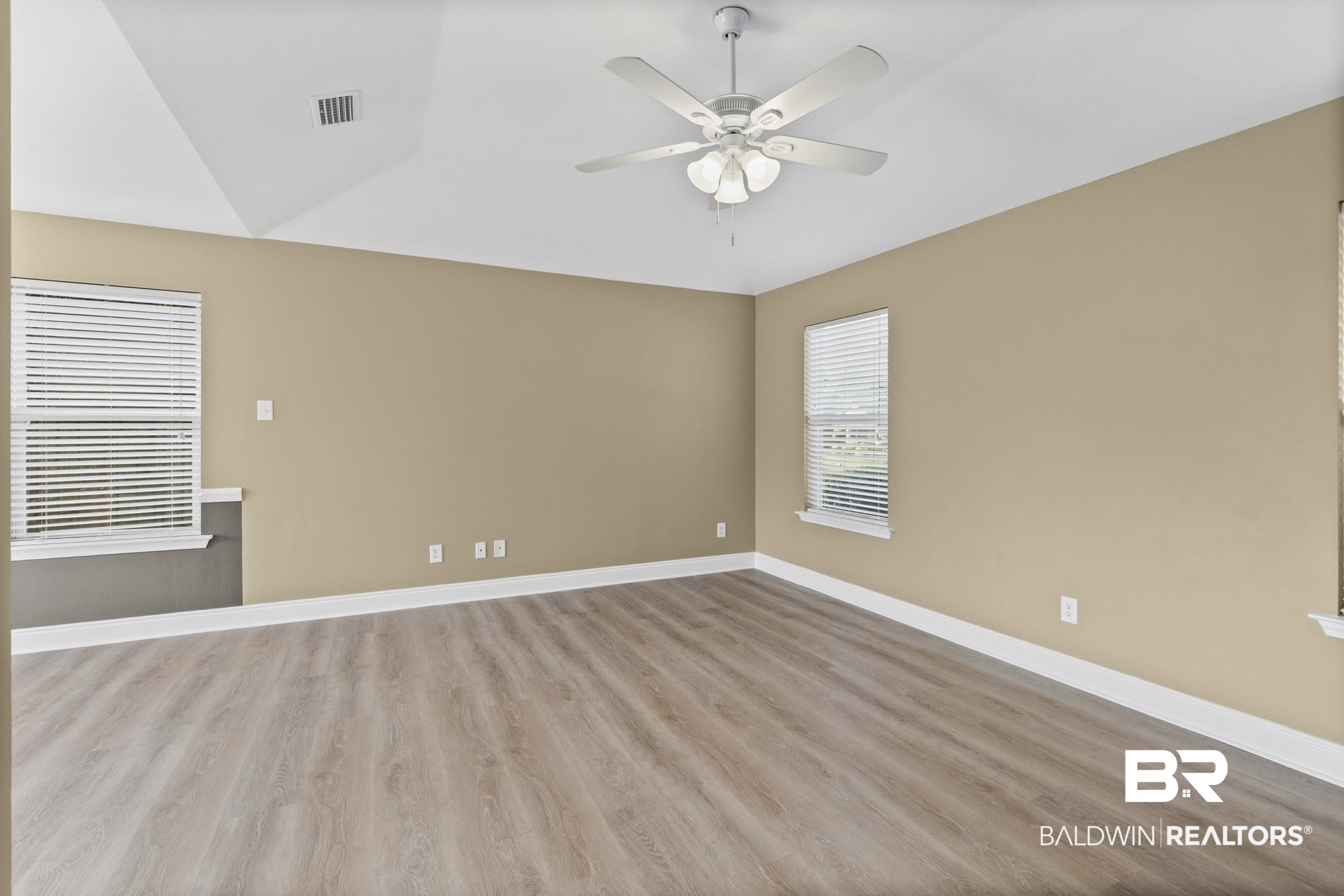 2084 Redpine Drive Semmes, AL 36575 - Photo 3 of 22 Unfurnished room featuring wood finished floors, a ceiling fan, and vaulted ceiling