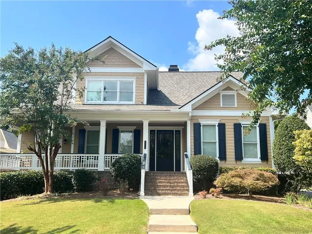 a front view of a house with garden