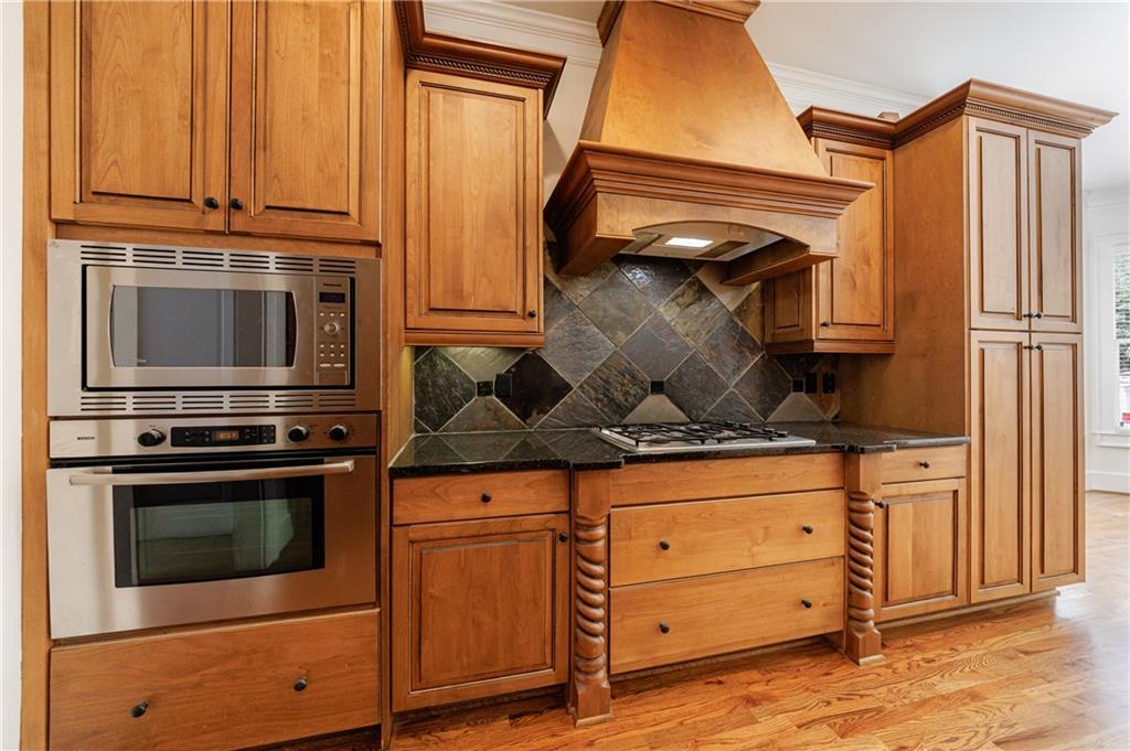 2370 Muskogee Lane Braselton, GA 30517 - Photo 12 of 27 a kitchen with granite countertop a stove and a microwave