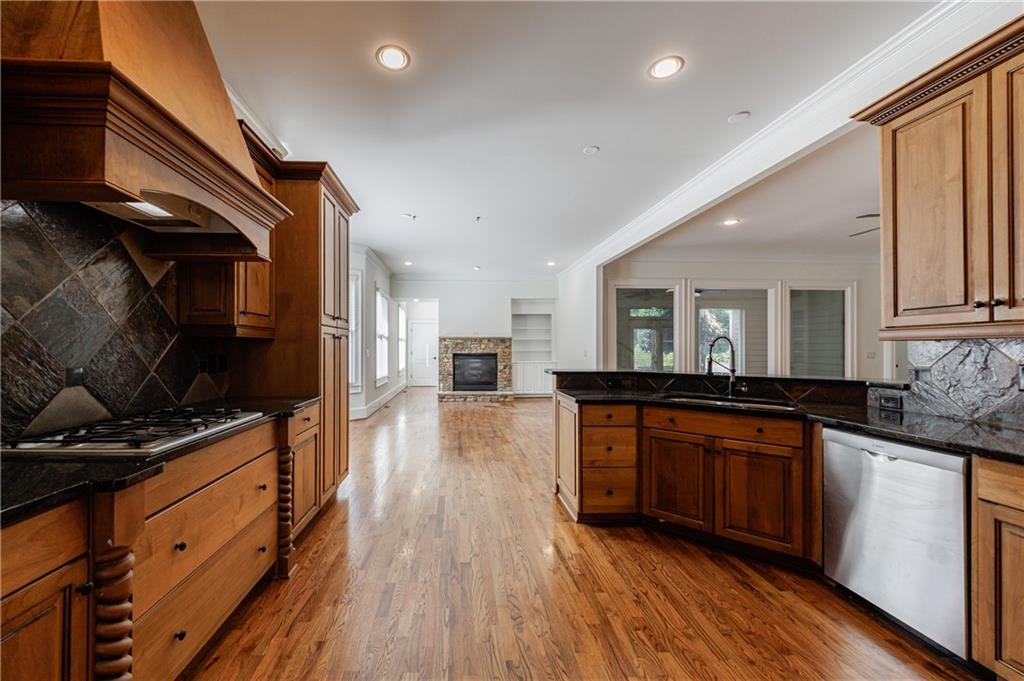 2370 Muskogee Lane Braselton, GA 30517 - Photo 17 of 27 a kitchen with stainless steel appliances granite countertop a stove and a wooden floors