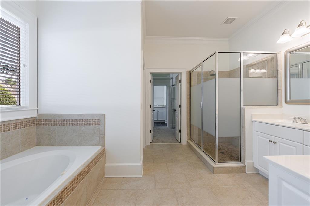 2370 Muskogee Lane Braselton, GA 30517 - Photo 18 of 27 a bathroom with a tub a sink and shower