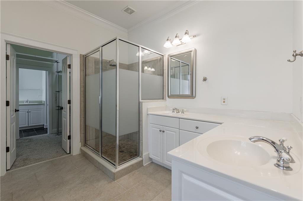 2370 Muskogee Lane Braselton, GA 30517 - Photo 19 of 27 a spacious bathroom with a shower sink and mirror