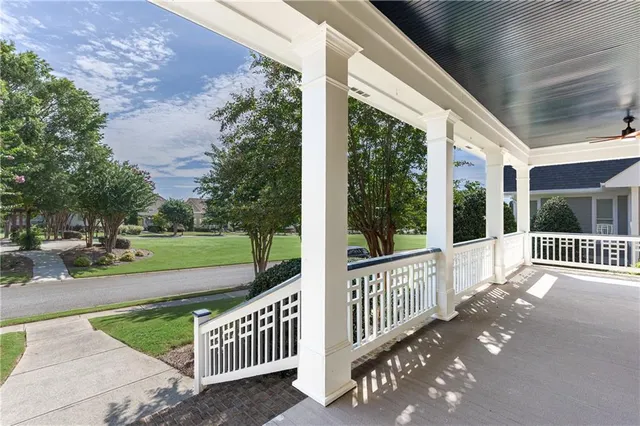 a view of a porch with wooden floor and fence