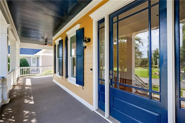 a view of a hallway with wooden floor and a living room