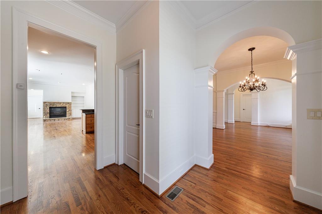 2370 Muskogee Lane Braselton, GA 30517 - Photo 6 of 27 a view of a hallway with wooden floor and a living room