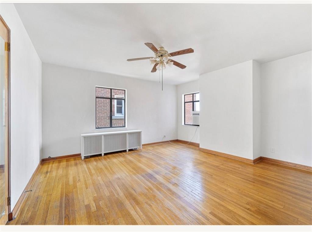 4745 Friendship Avenue Pittsburgh, PA 15224 - Photo 11 of 25 a view of empty room with wooden floor and fan