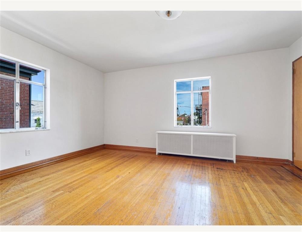 4745 Friendship Avenue Pittsburgh, PA 15224 - Photo 14 of 25 a view of an empty room with wooden floor and a window