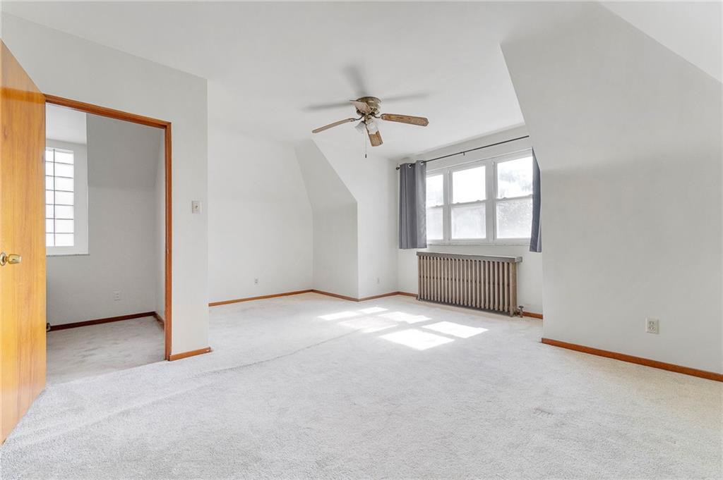 4745 Friendship Avenue Pittsburgh, PA 15224 - Photo 21 of 25 an empty room with chandelier fan and windows