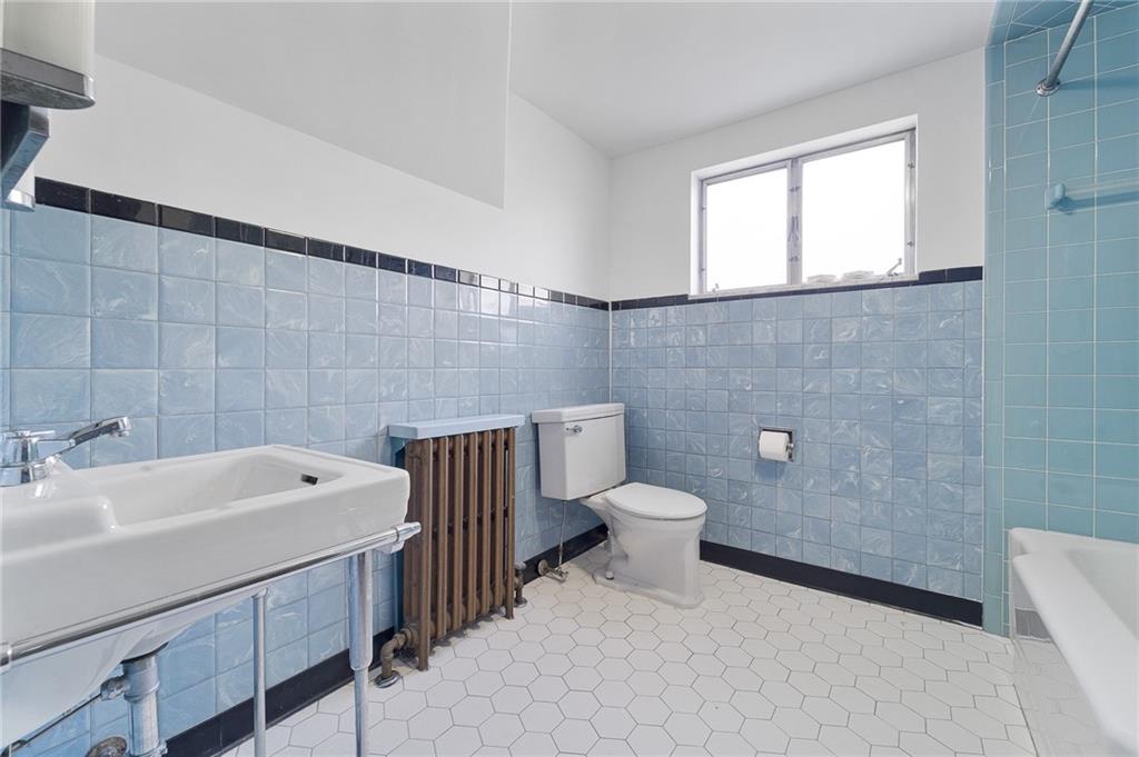 4745 Friendship Avenue Pittsburgh, PA 15224 - Photo 22 of 25 a bathroom with a sink a toilet and a mirror