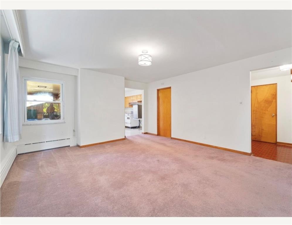 4745 Friendship Avenue Pittsburgh, PA 15224 - Photo 7 of 25 a view of an empty room with window and wooden floor
