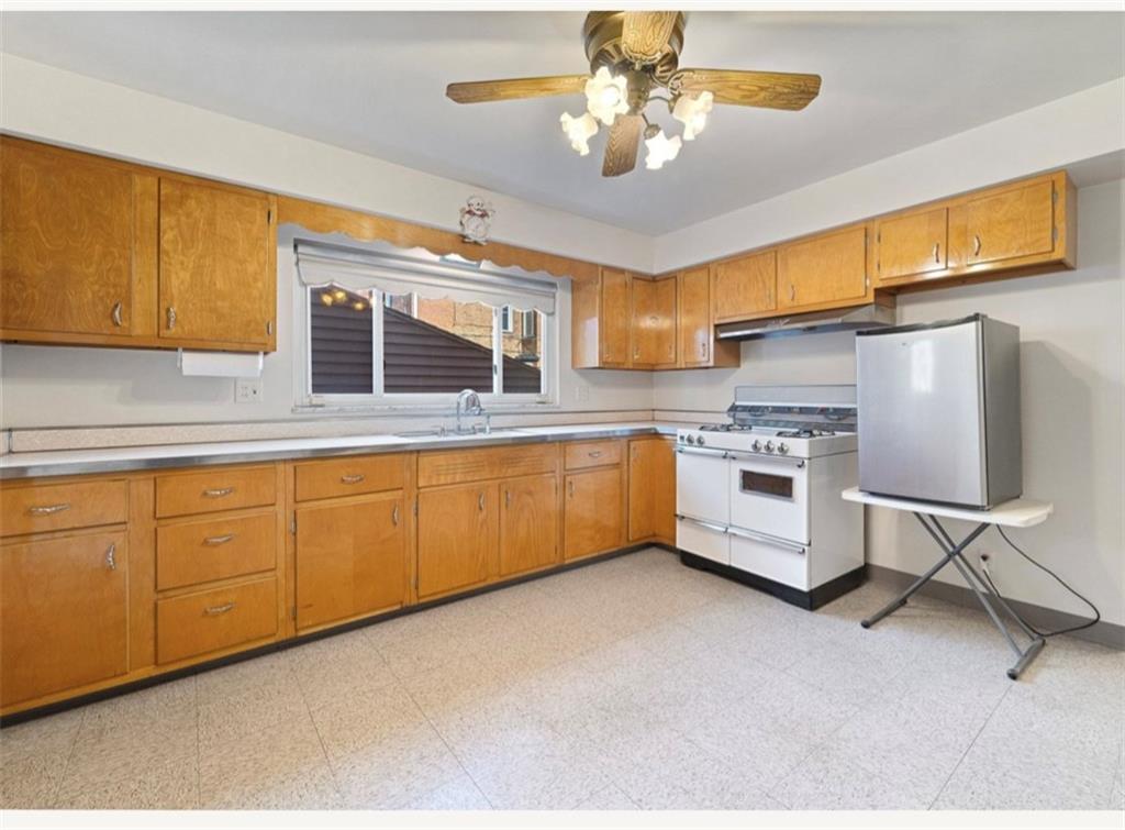 4745 Friendship Avenue Pittsburgh, PA 15224 - Photo 8 of 25 a kitchen with stainless steel appliances granite countertop a stove sink and cabinets