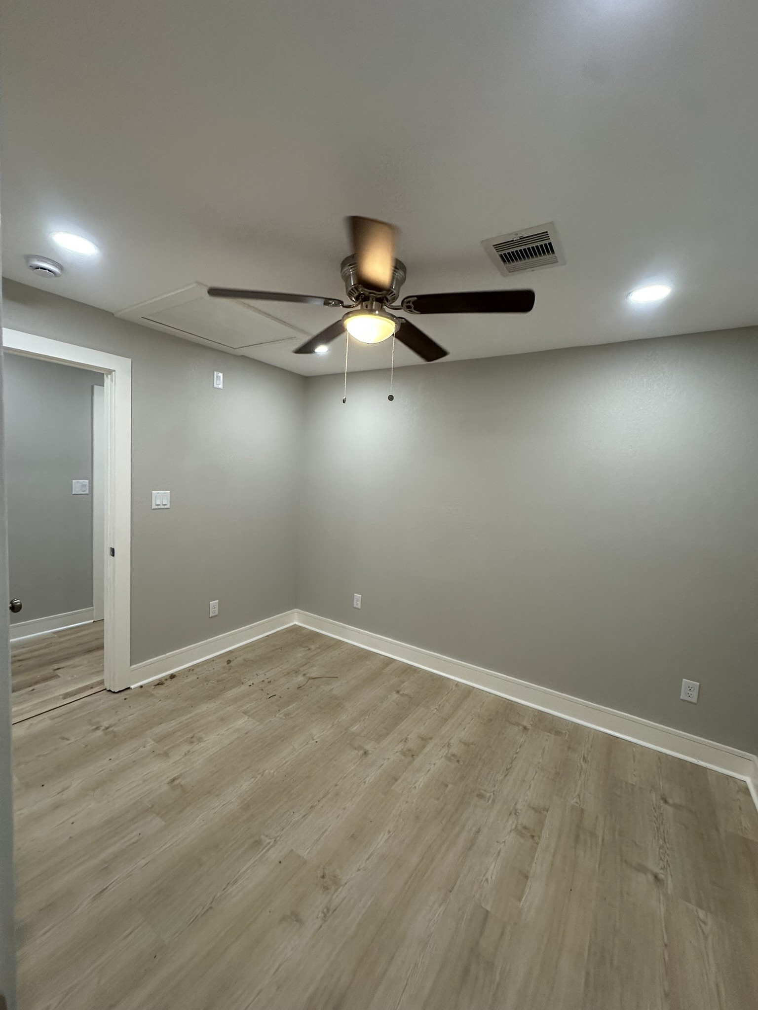 8223 Wallis Street Fulshear, TX 77441 - Photo 18 of 30 an empty room with wooden floor and windows