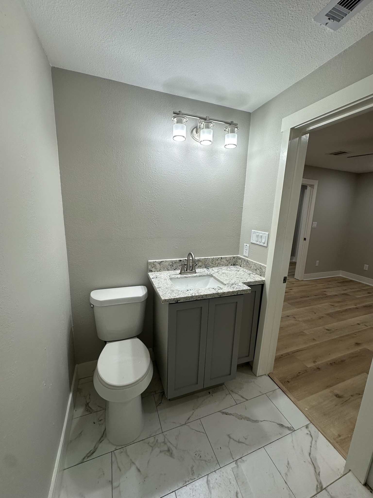 8223 Wallis Street Fulshear, TX 77441 - Photo 22 of 30 a bathroom with a toilet sink and mirror