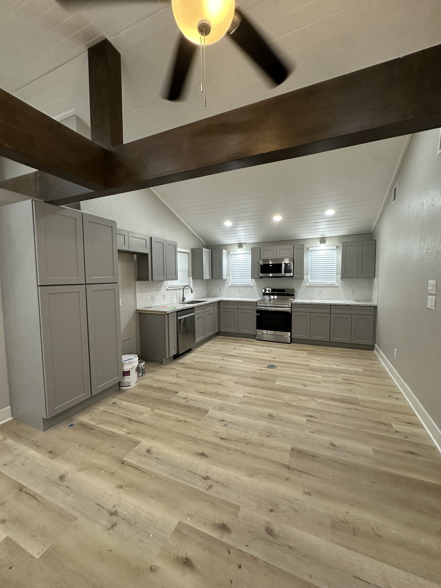 8223 Wallis Street Fulshear, TX 77441 - Photo 9 of 30 a large room with stainless steel appliances kitchen island granite countertop a stove and a refrigerator