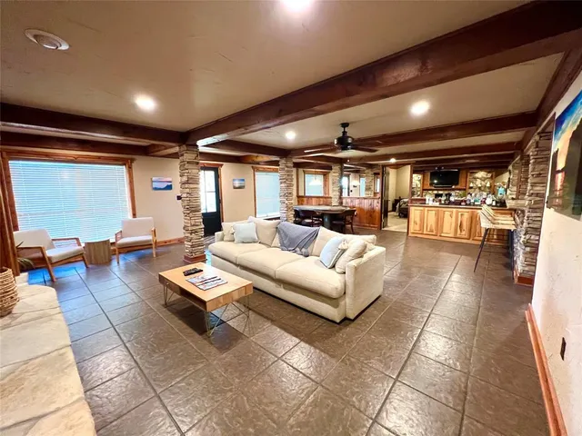 a large room with lots of furniture and a large window