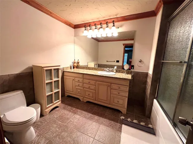 a spacious bedroom with a bed and a chandelier