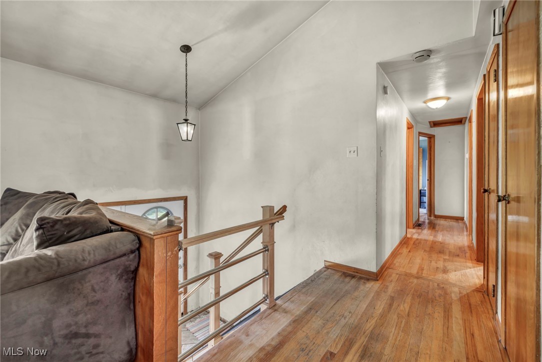 11996 Bower Road East Rochester, OH 44625 - Photo 15 of 49 Hallway featuring an upstairs landing, light wood finished floors, and vaulted ceiling