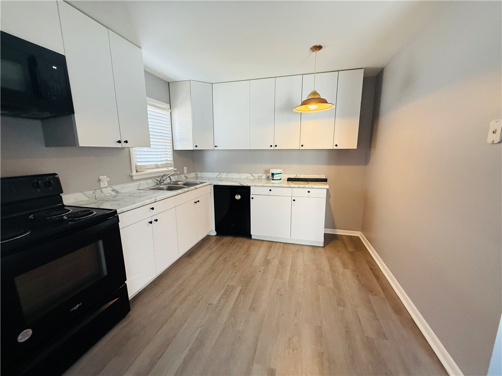 56 Maple Court Decatur, IL 62526 - Photo 8 of 31 a kitchen with a sink cabinets and wooden floor