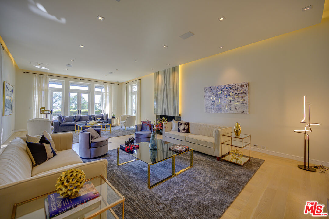 1235 Tower Road Beverly Hills, CA 90210 - Photo 13 of 31 a living room with lots of furniture and a rug