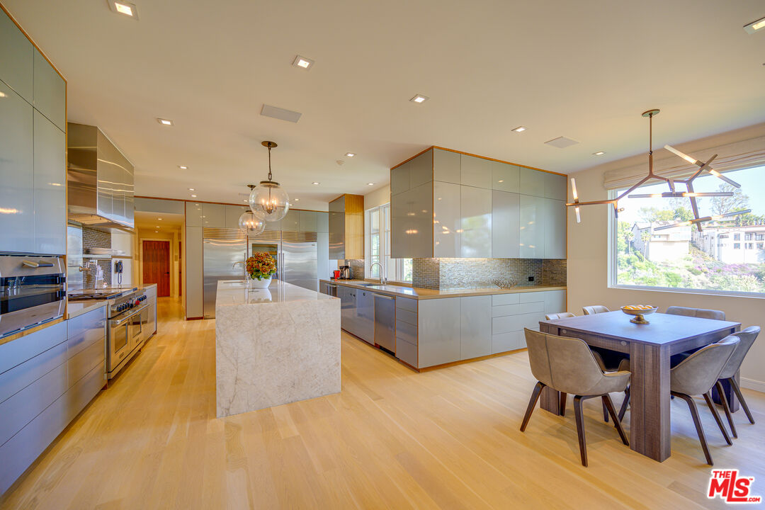 1235 Tower Road Beverly Hills, CA 90210 - Photo 14 of 31 a large kitchen with kitchen island a large island in it
