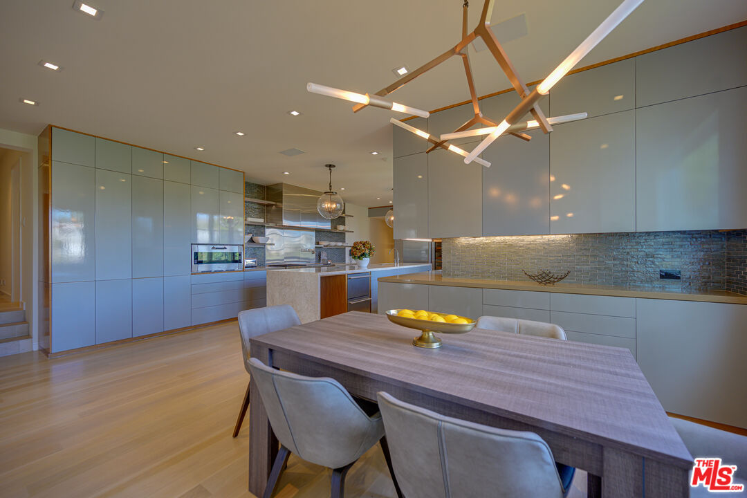 1235 Tower Road Beverly Hills, CA 90210 - Photo 15 of 31 a kitchen with a table chairs and refrigerator