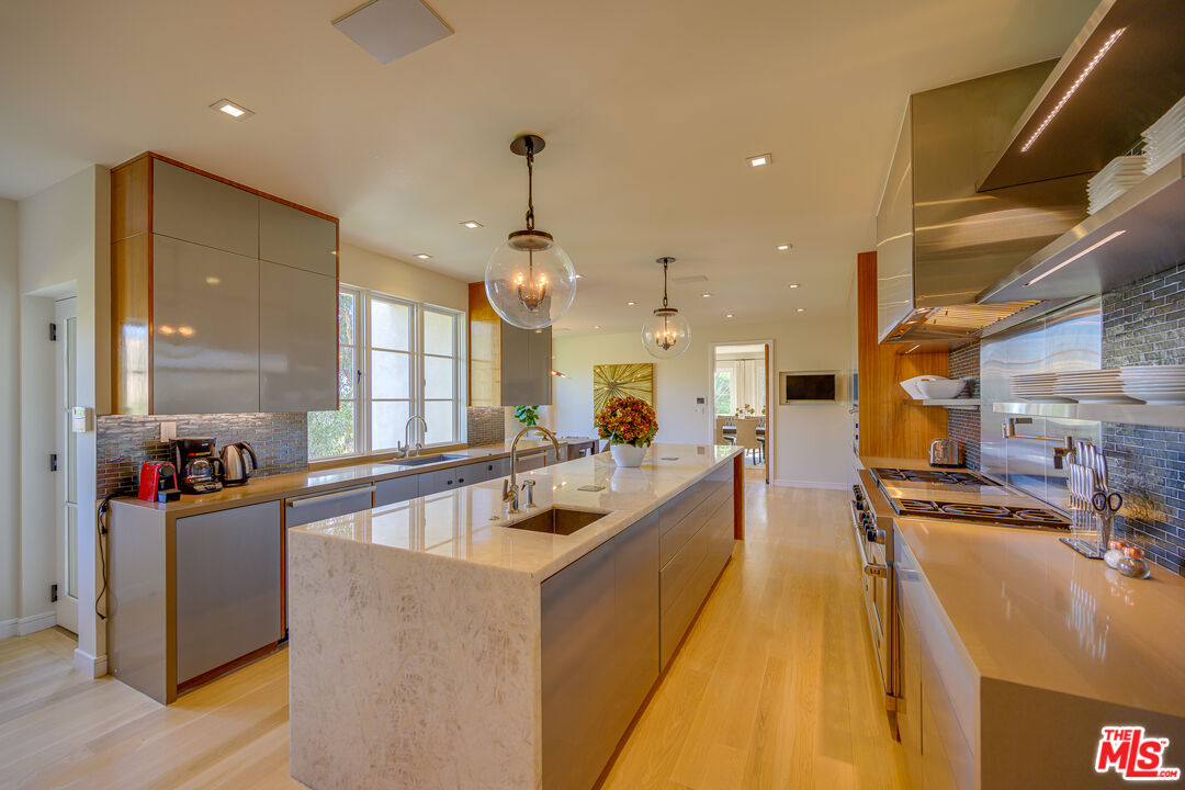 1235 Tower Road Beverly Hills, CA 90210 - Photo 16 of 31 a large kitchen with stainless steel appliances lots of counter top space