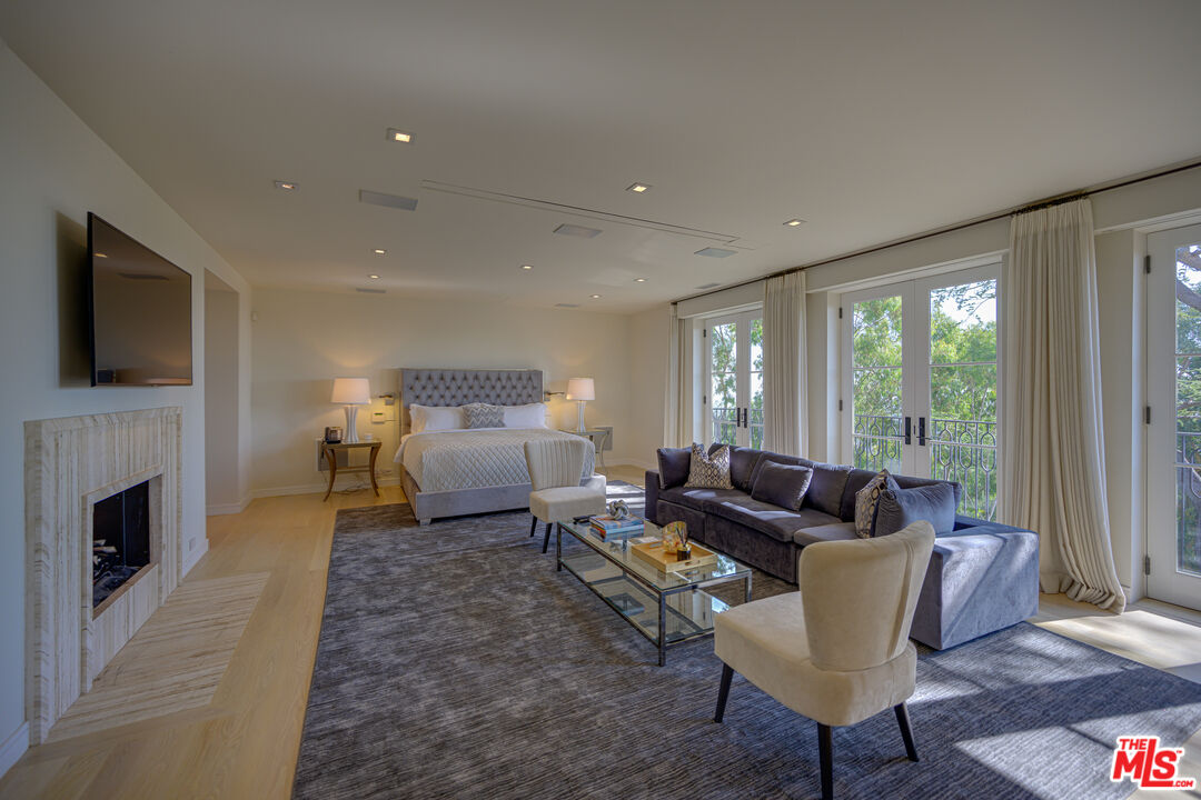 1235 Tower Road Beverly Hills, CA 90210 - Photo 18 of 31 a living room with furniture fireplace and a flat screen tv