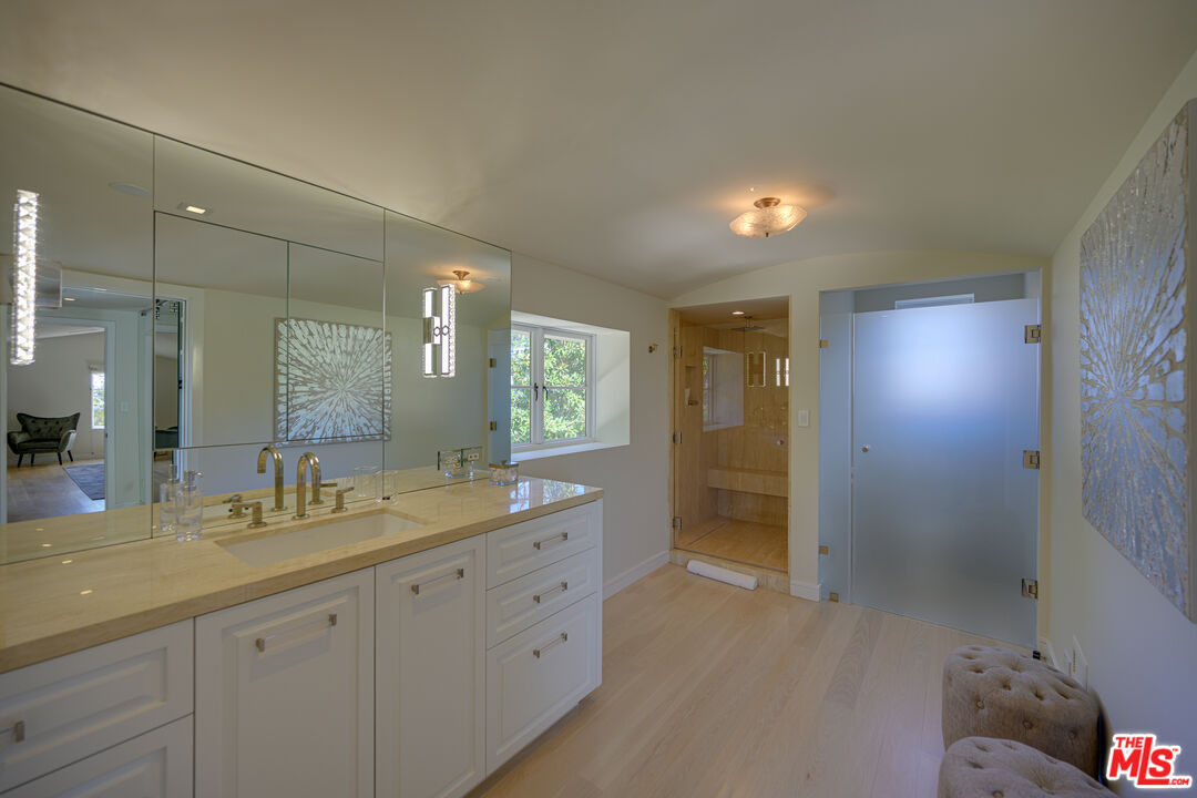 1235 Tower Road Beverly Hills, CA 90210 - Photo 24 of 31 a bathroom with a double vanity sink and a mirror