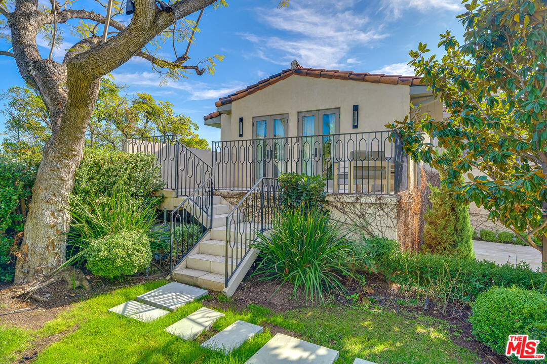 1235 Tower Road Beverly Hills, CA 90210 - Photo 27 of 31 a front view of a house with a yard