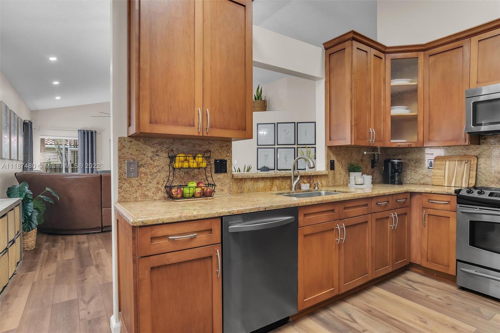 Jacaranda Plantation, FL 33324 - Photo 12 of 43 a kitchen with stainless steel appliances granite countertop a sink a stove and cabinets