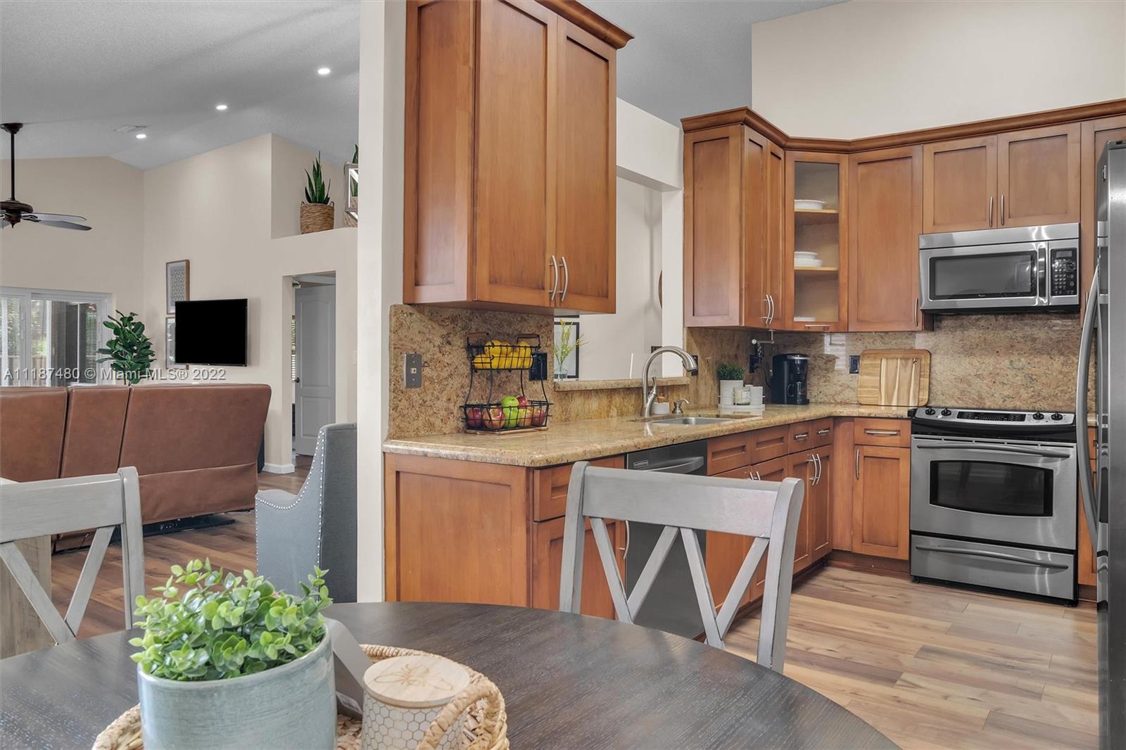 Jacaranda Plantation, FL 33324 - Photo 14 of 43 a kitchen with a stove a sink and a microwave