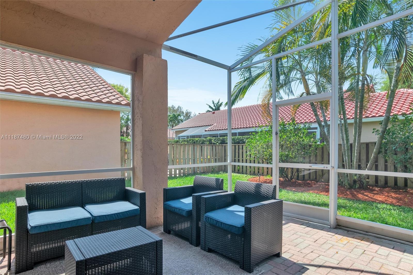 Jacaranda Plantation, FL 33324 - Photo 16 of 43 a view of a deck with couches table and chairs with wooden floor and fence
