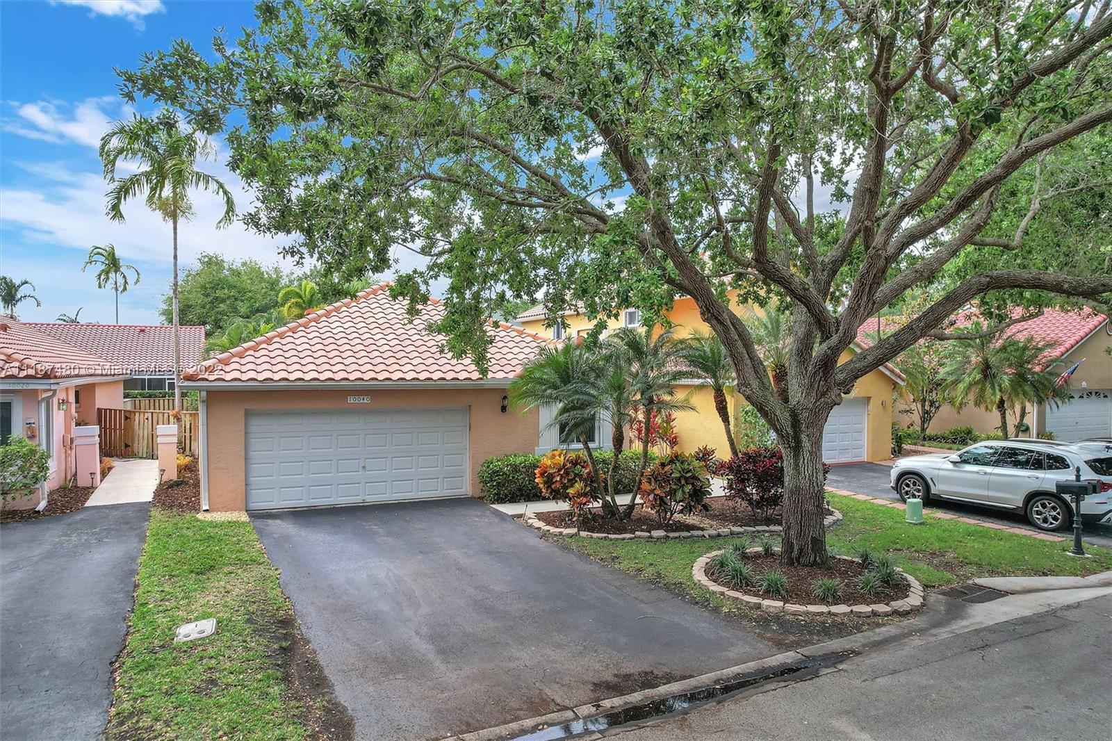 Jacaranda Plantation, FL 33324 - Photo 2 of 43 a front view of a house with a garden and trees