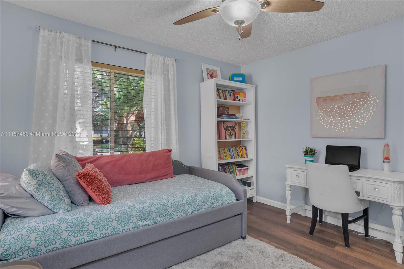 Jacaranda Plantation, FL 33324 - Photo 23 of 43 a bedroom with a bed a table and a large window