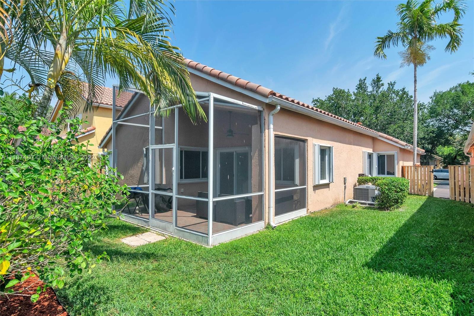 Jacaranda Plantation, FL 33324 - Photo 28 of 43 a view of a backyard with plants and a large tree