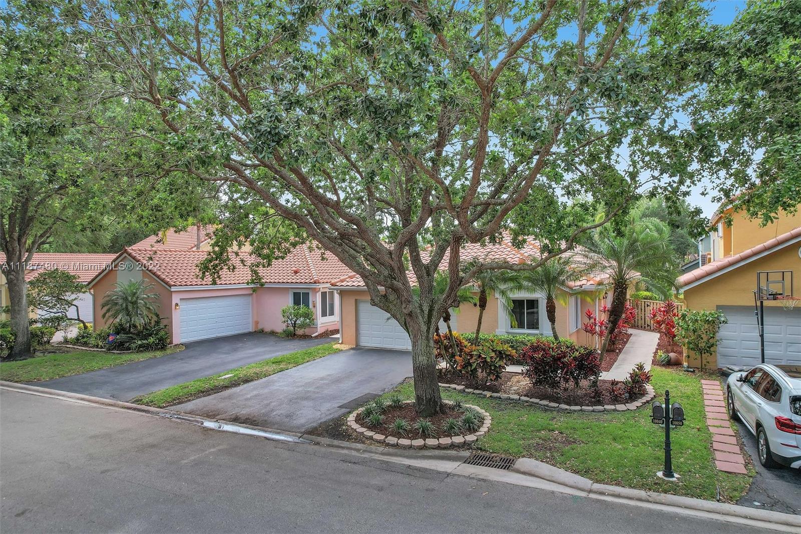 Jacaranda Plantation, FL 33324 - Photo 30 of 43 a front view of a house with a garden and trees