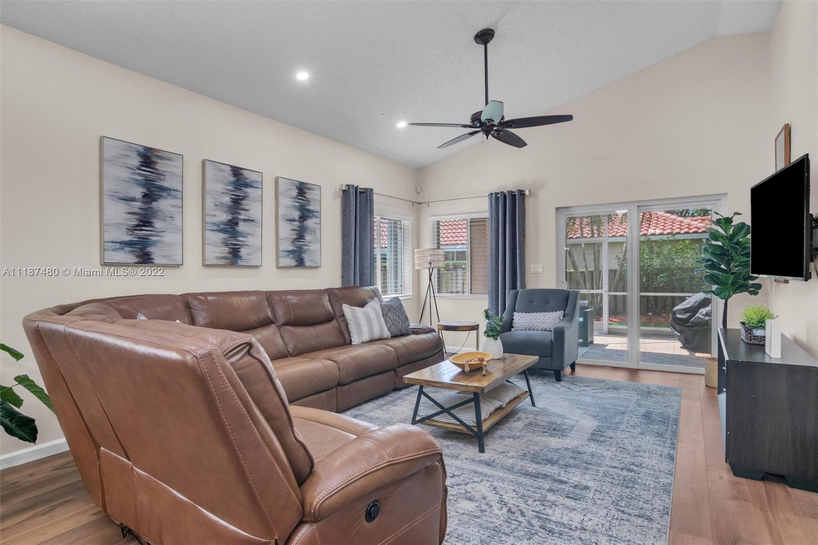 Jacaranda Plantation, FL 33324 - Photo 6 of 43 a living room with furniture a flat screen tv and a large window
