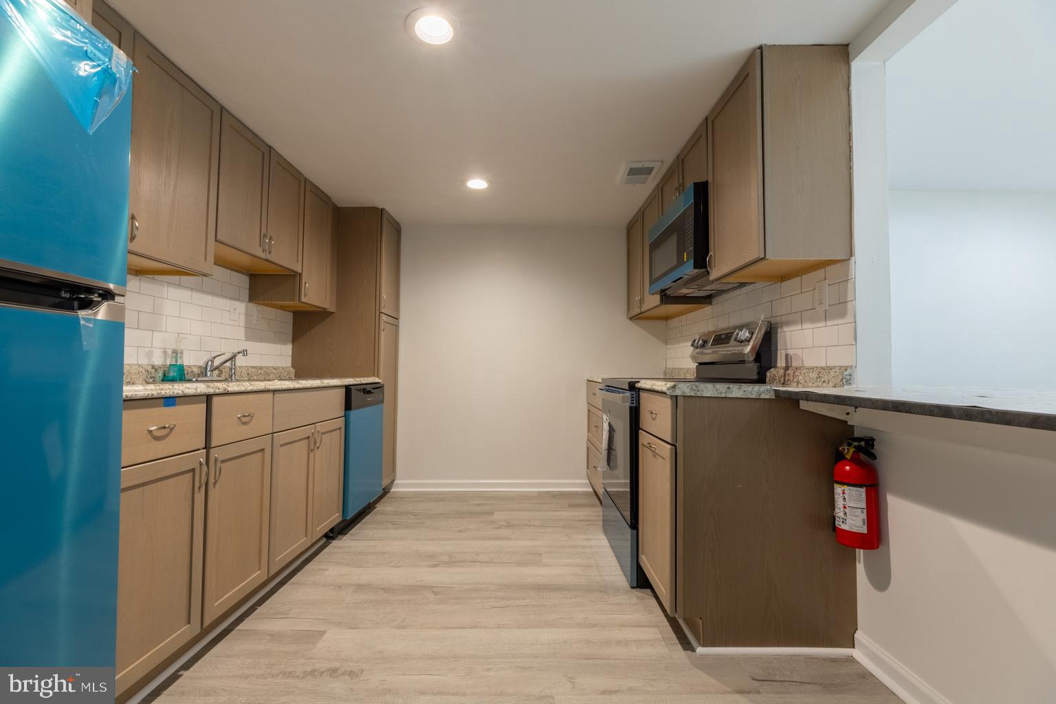 5 Farragut Court Willingboro, NJ 08046 - Photo 14 of 51 a kitchen with granite countertop a refrigerator stove and a sink