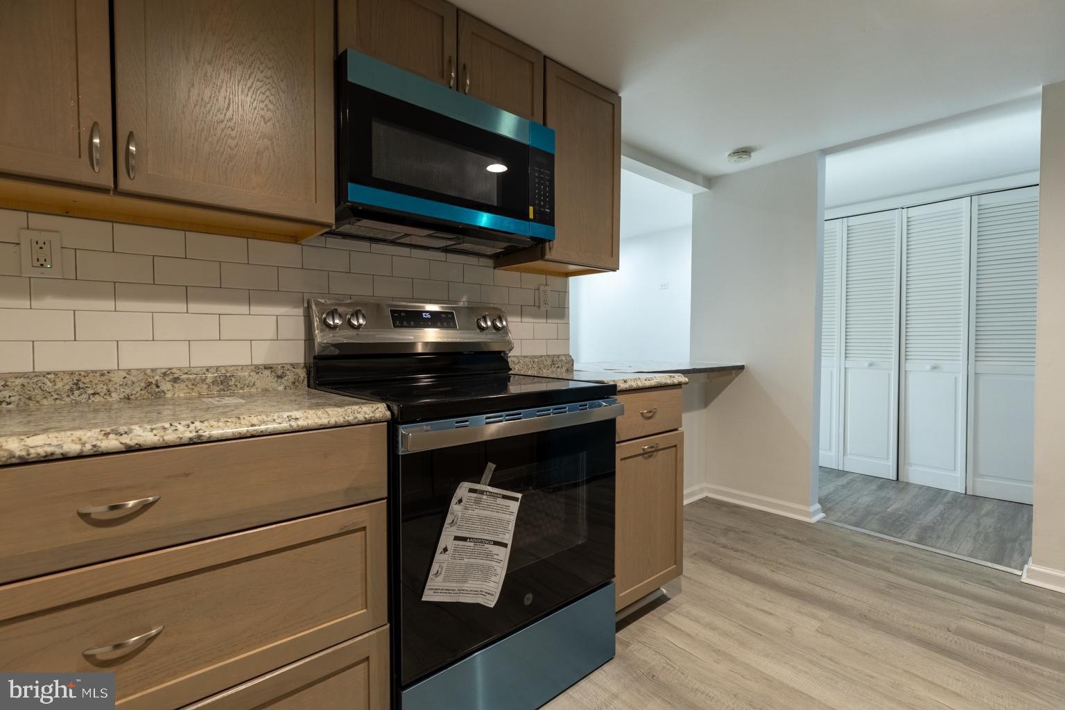 5 Farragut Court Willingboro, NJ 08046 - Photo 17 of 51 a kitchen with granite countertop a stove and a microwave