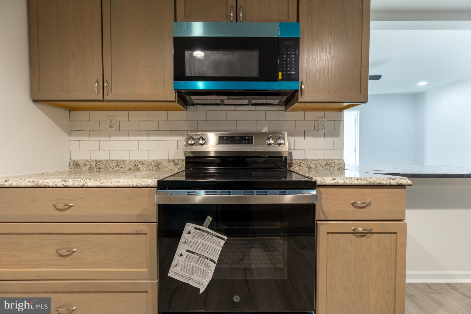 5 Farragut Court Willingboro, NJ 08046 - Photo 18 of 51 a kitchen with stainless steel appliances granite countertop a stove and a microwave