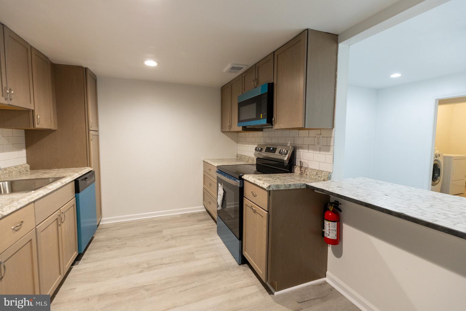 5 Farragut Court Willingboro, NJ 08046 - Photo 50 of 51 a kitchen with stainless steel appliances granite countertop a sink stove and microwave