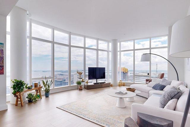 a living room with furniture and floor to ceiling window