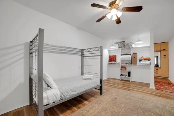 a bedroom with furniture and wooden floor