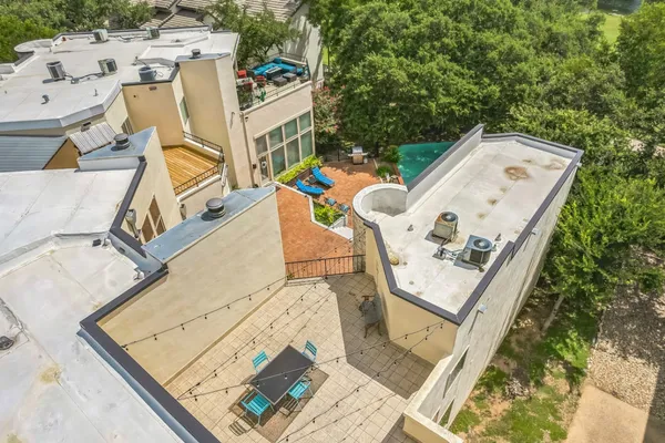 an aerial view of a house with swimming pool and lounge chairs