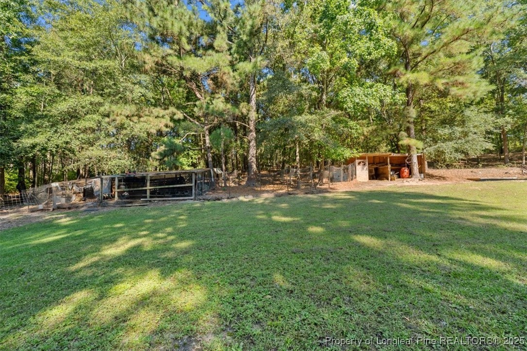 11891 Aberdeen Road Aberdeen, NC 28315 - Photo 28 of 35 a view of a house with a backyard