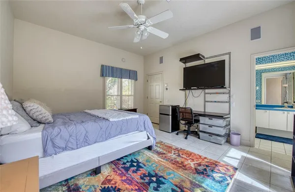 a large bed sitting in a bedroom next to a window