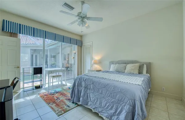 a living room with furniture and a flat screen tv with kitchen view